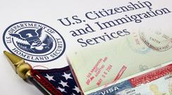 USCIS documents and American flag displayed.